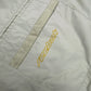 Reebok Windbreaker creme goldener Reebok Schriftzug Detail