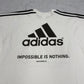 Adidas Bikila.com Vintage Eventshirt in Weiß, Logo-Closeup
